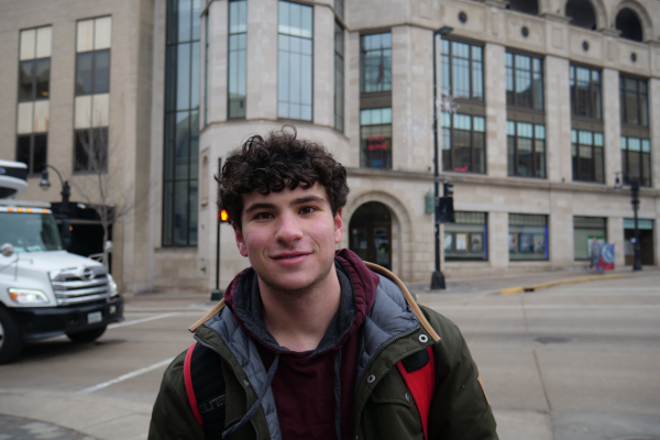 Photo of man standing outside in front of an office building.